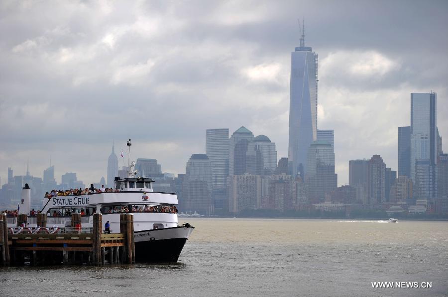 A ferry is docked at the Statue of Liberty at Liberty Island in New York, the United States, on July 4, 2013, the U.S. Independence Day. The Statue of Liberty and Liberty Island reopened to the public on Thursday for the first time since Hurricane Sandy made landfall on Oct. 29, 2012. (Xinhua/Wang Lei) 