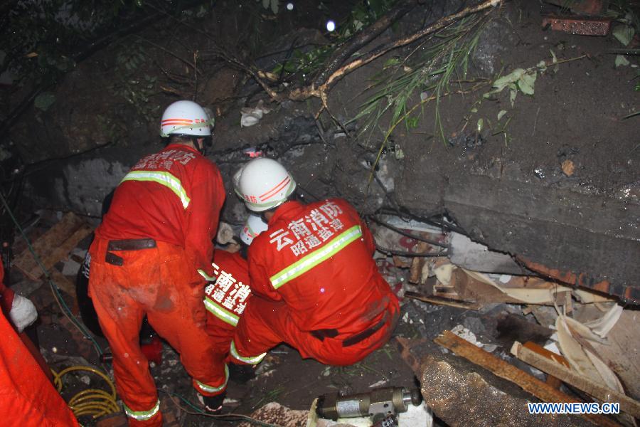 Rescuers search for survivors after a landslide in Gaoqiao Village of Yanjin County in Zhaotong City, southwest China's Yunnan Province, July 5, 2013. Nine people were buried by the landslide which happened on Friday morning. Four of them have been saved, while the other five are still missing. The rescue operation is underway. (Xinhua/Luo Chengxian)