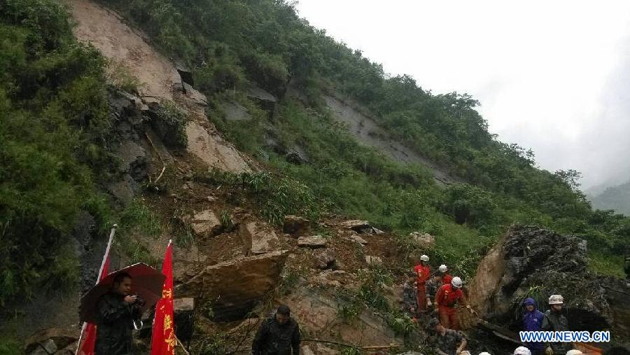 Rescuers search for survivors after a landslide in Gaoqiao Village of Yanjin County in Zhaotong City, southwest China's Yunnan Province, July 5, 2013. Nine people were buried by the landslide which happened on Friday morning. Four of them have been saved, while the other five are still missing. The rescue operation is underway. (Xinhua/Yuan Zhengxiong)