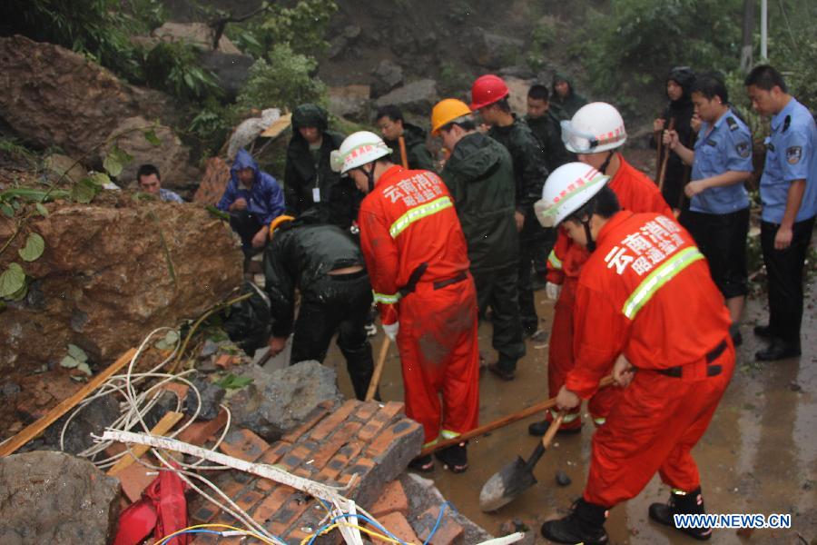 Rescuers search for survivors after a landslide in Gaoqiao Village of Yanjin County in Zhaotong City, southwest China's Yunnan Province, July 5, 2013. Nine people were buried by the landslide which happened on Friday morning. Four of them have been saved, while the other five are still missing. The rescue operation is underway. (Xinhua/Luo Chengxian) 