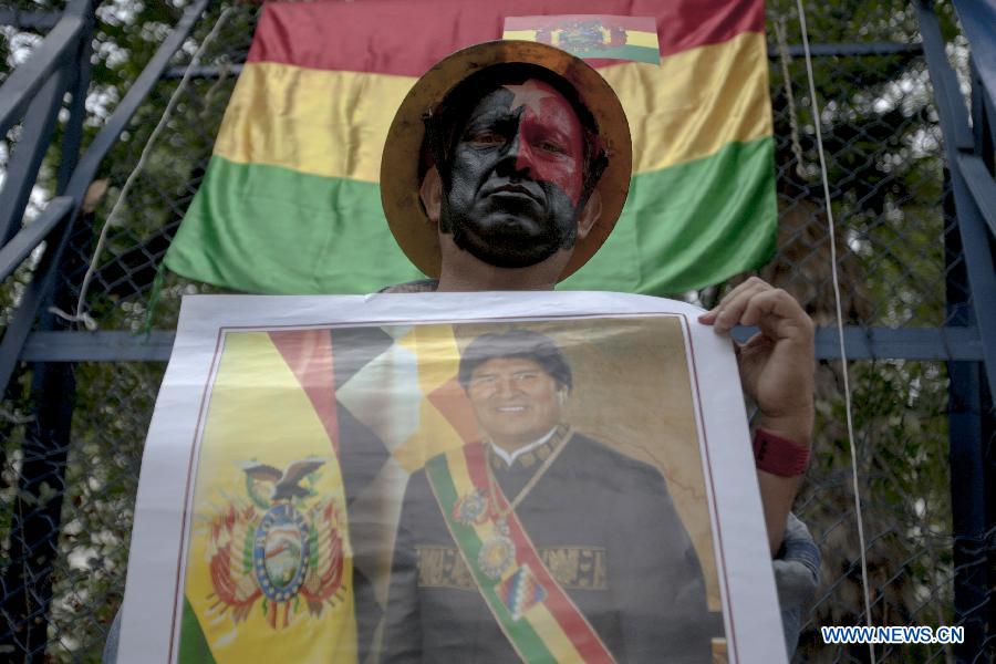 A man holds a photo of Bolivian President Evo Morales during a demonstration in support of the Bolivian President Evo Morales in front of U.S. embassy in Mexico, in Mexico City, capital of Mexico, on July 4, 2013. Bolivian President Evo Morales's plane refueled on the island of Gran Canaria and headed back home, after being diverted to Vienna on Tuesday on suspicion of harburing fugitive U.S. leaker Edward Snowden. The plane was grouned in Vienna for 13 hours, after France and Portugal allegedly close their airspace to the plane. (Xinhua/Alejandro Ayala) 