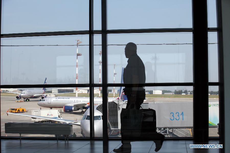 A passenger walks in the transit area of Terminal E at Moscow's Sheremetyevo International Airport, Russia, July 5, 2013. Snowden, via his legal advisor Sarah Harrison from WikiLeaks, earlier this week handed over an asylum request to Russian authorities but withdrew it later. He fled to Moscow from Hong Kong and has reportedly stayed since June 23 in the transit area of Moscow's Sheremetyevo airport. (Xinhua/Liu Yiran)