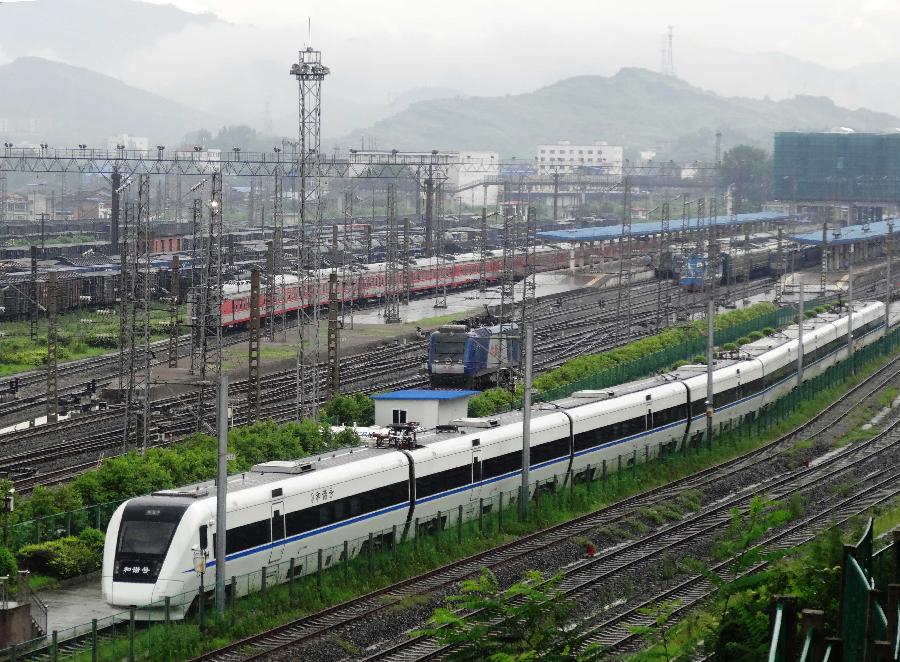 A train is stranded at the Dazhou Railway Station in Dazhou, southwest China's Sichuan Province, July 5, 2013. A new round of heavy rainfall battered Dazhou on Friday morning, making several trains suspended and late. (Xinhua/Deng Liangkui)