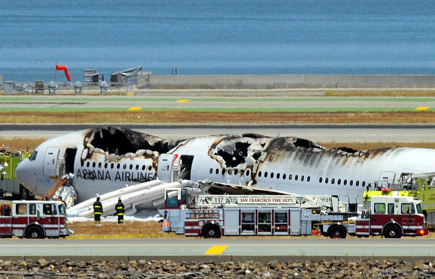 Fire crews work at the crash site at San Francisco International Airport on July 6. (Xinhua/AFP)