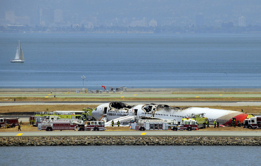 Fire crews work at the crash site at San Francisco International Airport on July 6. (Xinhua/AFP)