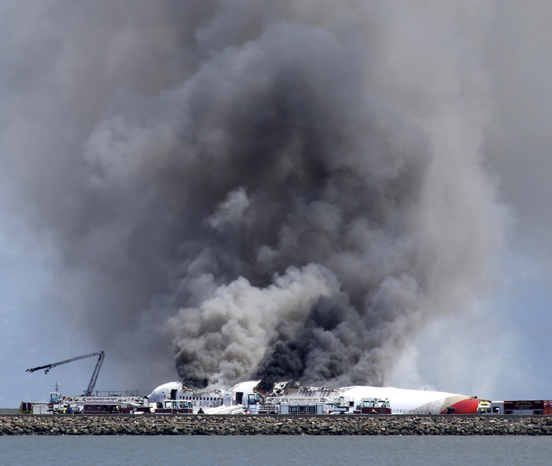 Fire crews attempt to quench the blaze the Asian Flight 214 crashed at the San Francisco International Airport, July 6, 2013. (Photo/Xinhua)