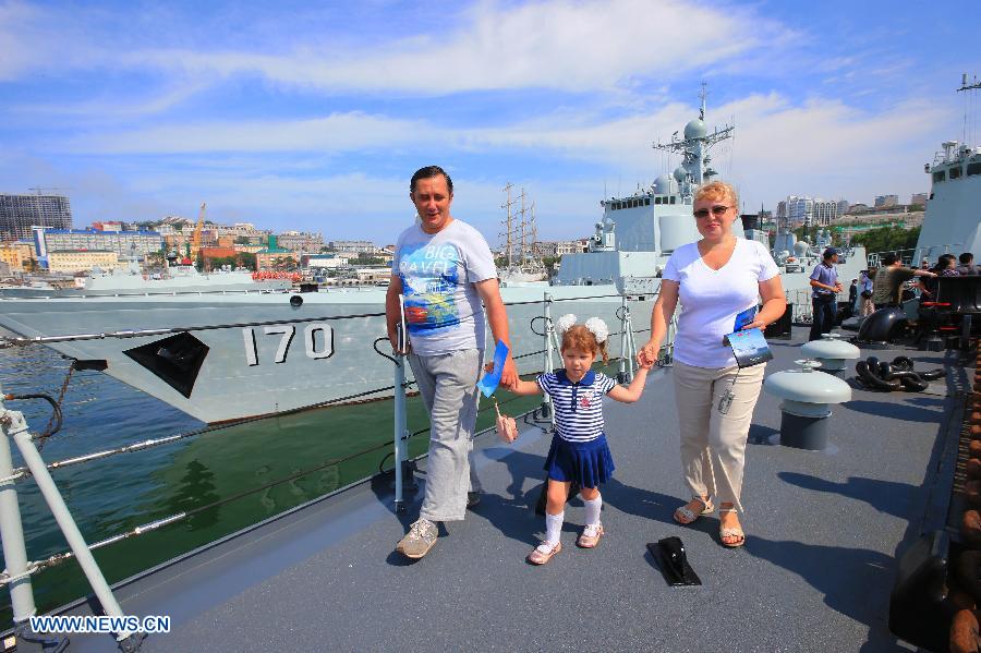 Local people visit the Chinese Navy Shijiazhuang guided-missile destroyer at the port in Vladivostok, Russia, July 6, 2013. The Chinese Navy Shijiazhuang guided-missile destroyer, which is participating in the "Joint Sea-2013" joint naval drills of China and Russia, opened to the public and Russian navy soldiers on Saturday. (Xinhua/Zha Chunming)