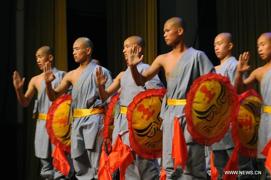 Performers of the Yandong Shaolin Kungfu troupe show their Kungfu during a performance held at the Worker's Cultural Palace, Taiyuan, capital of north China's Shanxi Province, July 6, 2013. The martial art troupe have their performers trained in the renowned Shaolin Temple, and staged performances worldwide in the hope of promoting Shaolin-style martial arts and Chinese culture. (Xinhua/Fan Minda)  