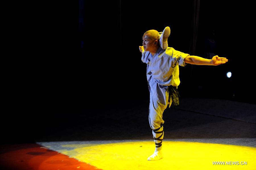 A performer of the Yandong Shaolin Kungfu troupe shows "Tongzi Kungfu" during a performance held at the Worker's Cultural Palace, Taiyuan, capital of north China's Shanxi Province, July 6, 2013. The martial art troupe have their performers trained in the renowned Shaolin Temple, and staged performances worldwide in the hope of promoting Shaolin-style martial arts and Chinese culture. (Xinhua/Fan Minda) 