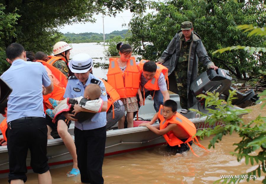 Rescuers evacuate villagers stranded by floods in Hebei Village, Qingyang County, east China's Anhui Province, July 6, 2013. Torrential rainfalls battered Anhui from July 4 to 6, and made some 30 counties in the province flooded. (Xinhua/Chen Jian) 
