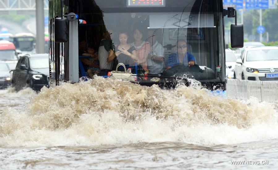 A bus drives on a flooded road in Wuhan, capital of central China's Hubei Province, July 7, 2013. Wuhan was hit by the heaviest rainstorm in five years from Saturday to Sunday. The local meteorologic center has issued red alert for rainstorm for many times in sequence. (Xinhua/Cheng Min)