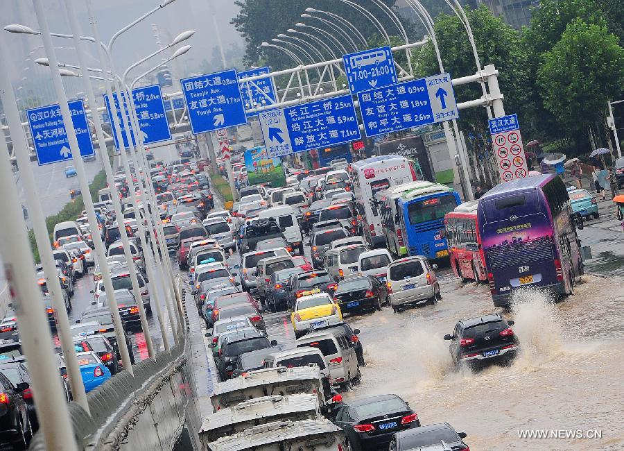 Photo taken on July 7, 2013 shows the flooded road in Wuchang District of Wuhan, capital of central China's Hubei Province. Wuhan was hit by the heaviest rainstorm in five years from Saturday to Sunday. The local meteorologic center has issued red alert for rainstorm for many times in sequence. (Xinhua/Xiao Yijiu) 
