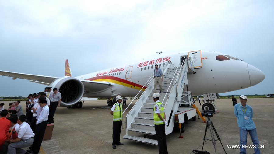 A Boeing 787 Dreamliner parks at the Haikou Meilan International Airport in Haikou, capital of south China's island of Hainan Province, July 7, 2013. Haian Airlines held a ceremony here to welcome the arrival of its first Boeing 787 Dreamliner. Mou Wei, vice president of Hainan Airlines, said on July 4 that the first 213-seat Dreamliner will serve the domestic route between Beijing and Haikou, capital of south China's Hainan Province, with 36 seats reserved for business class and 177 for economy. (Xinhua/Zhao Yingquan) 