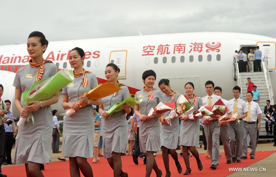 Crew members of the Haian Airlines disembark from a Boeing 787 Dreamliner at the Haikou Meilan International Airport in Haikou, capital of south China's island of Hainan Province, July 7, 2013. Haian Airlines held a ceremony here to welcome the arrival of its first Boeing 787 Dreamliner. Mou Wei, vice president of Hainan Airlines, said on July 4 that the first 213-seat Dreamliner will serve the domestic route between Beijing and Haikou, capital of south China's Hainan Province, with 36 seats reserved for business class and 177 for economy. (Xinhua/Zhao Yingquan)