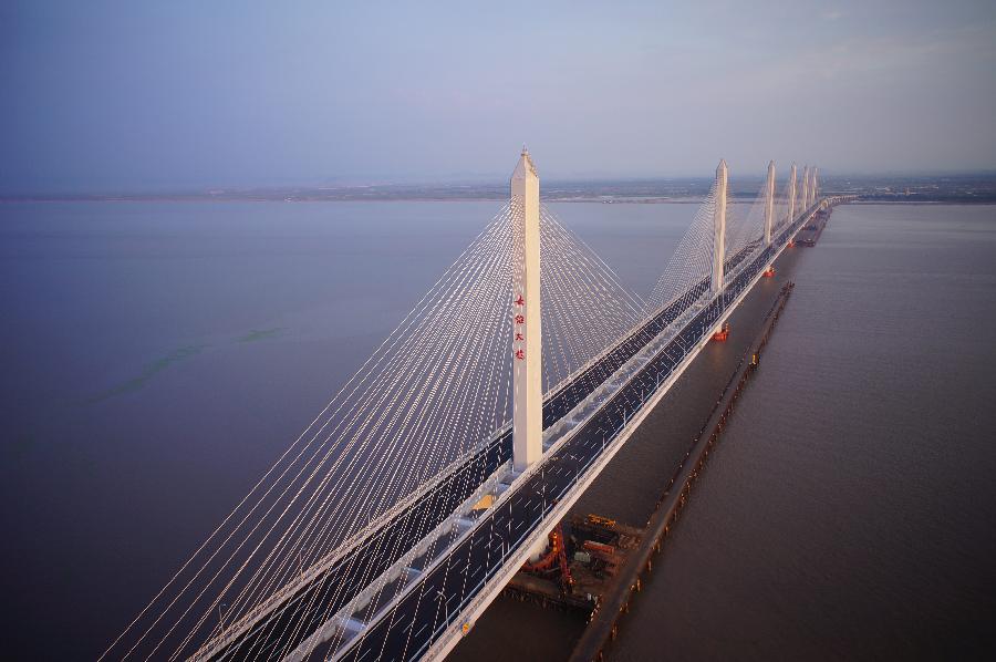 Photo taken on June 17, 2013 shows the Jiaxing-Shaoxing Sea Bridge in Shaoxing, east China's Zhejiang Province, June 17, 2013. The linking roads of the bridge was completed on July 6. The bridge is expected to be open to traffic in mid-July. With a span of 10 kilometers over the Hangzhou Bay, it is the world's longest and widest multi-pylon cable-stayed bridge. (Xinhua/Yuan Yun)