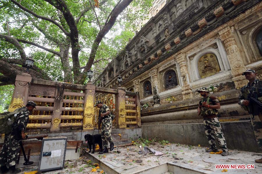 Security officers inspect the site of an explosion on the campus of the Mahabodhi Temple, the Buddhist Great Awakening temple, in Bodhgaya, about 130 kilometers (80 miles) south of Patna, the capital of the eastern Indian state of Bihar, July 7, 2013. A series of small blasts hit three Buddhist temples in eastern India early Sunday, injuring at least two people, police said. (Xinhua)