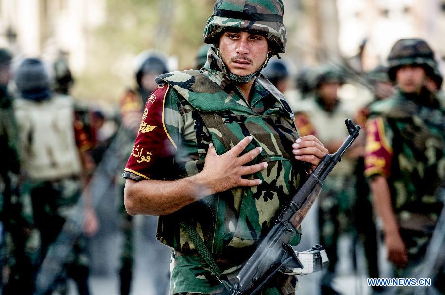 A soldier stands outside the Republican Guards headquarters in Nasr city, Cairo, Egypt, July 6, 2013. (Xinhua/Li Muzi) 