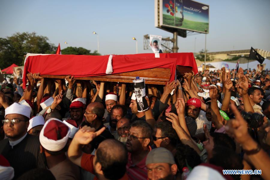 Supporters of ousted Egyptian President Mohamed Morsi carry the coffins of people killed a day before during the clashes outside the Republican Guard headquarter, in Nasr City, Cairo, Egypt, July 6, 2013. (Xinhua/Wissam Nassar)