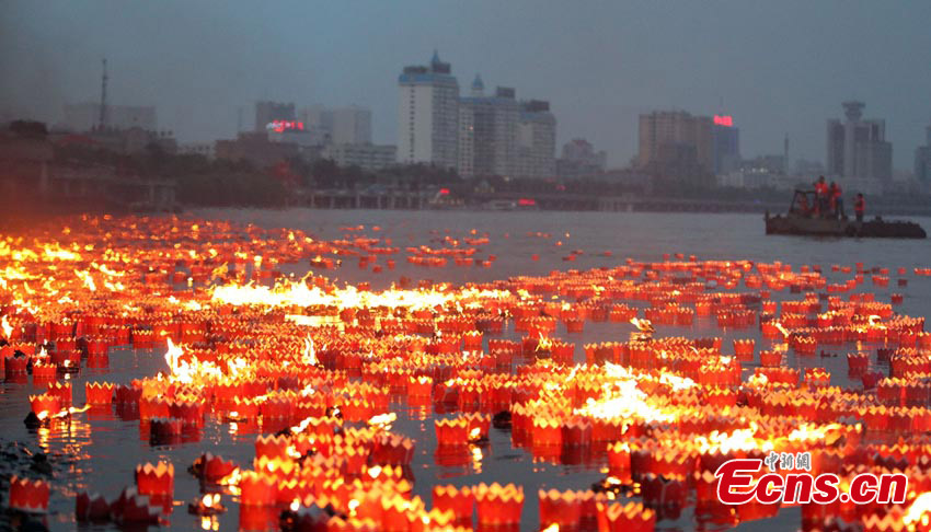 River lanterns float on the Songhua River in Northeast China's Jilin Province, July 7, 2013. Altogether 14,630 lanterns were released in the river, setting a new Guinness World Record.  (CNS/Cang Yan)