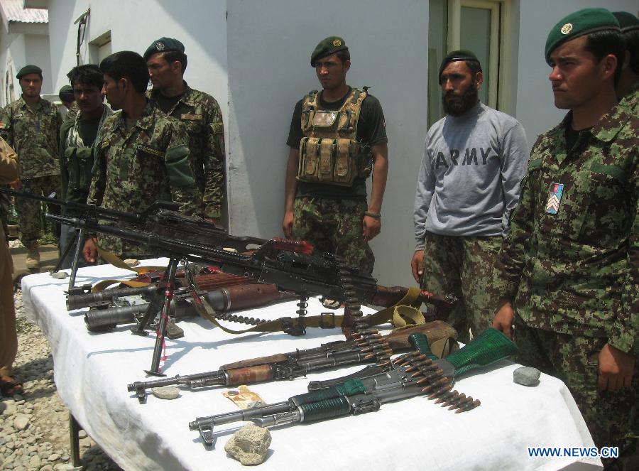 Afghan army soldiers display weapons of Taliban after an operation against Taliban in Laghman province in eastern of Afghanistan on July 7, 2013. At least five Taliban fighters killed by Afghan army soldiers during an operation in Laghman province on Sunday Army officials said. (Xinhua/Tahir Safi)