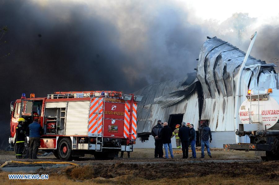 Firemen try to extinguish a fire in a factory that produces candy containers and labels in Buenos Aires, Argentina, on July 7, 2013. The fire left at least on person injured and completly destroyed the main hall of the factory, according to the local press. (Xinhua/Alejandro Moritz/TELAM)