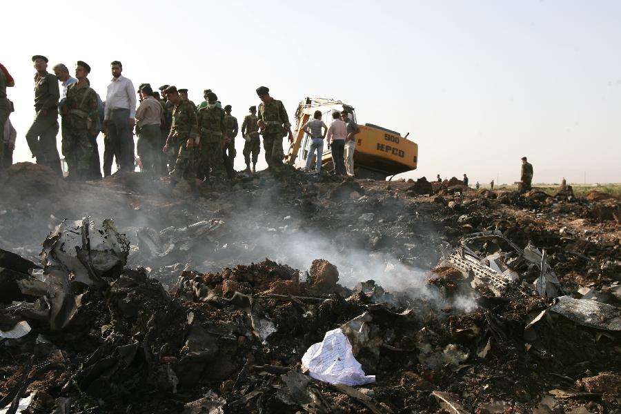 Debris is seen at the crash site of the Caspian Airlines plane, which fell into farmland near the city of Qazvin, northwest of Tehran on July 15, 2009. The Iranian airliner en route to neighbouring Armenia crashed, killing all 168 people on board in the worst air disaster in Iran in recent years. (Xinhua/Liang Youchang)   