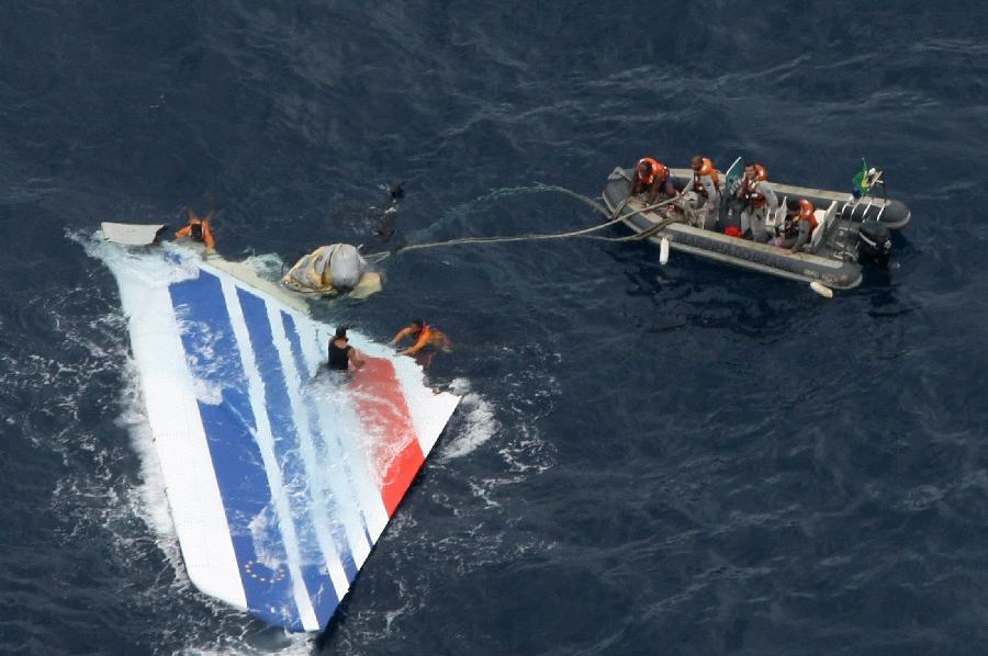 Brazilian Navy sailors pick a piece of debris from Air France flight AF447 out of the Atlantic Ocean, some 745 miles (1,200 km) northeast of Recife, in this June 8, 2009 file handout photo distributed by the Navy. (Xinhua/Reuters File Photo)