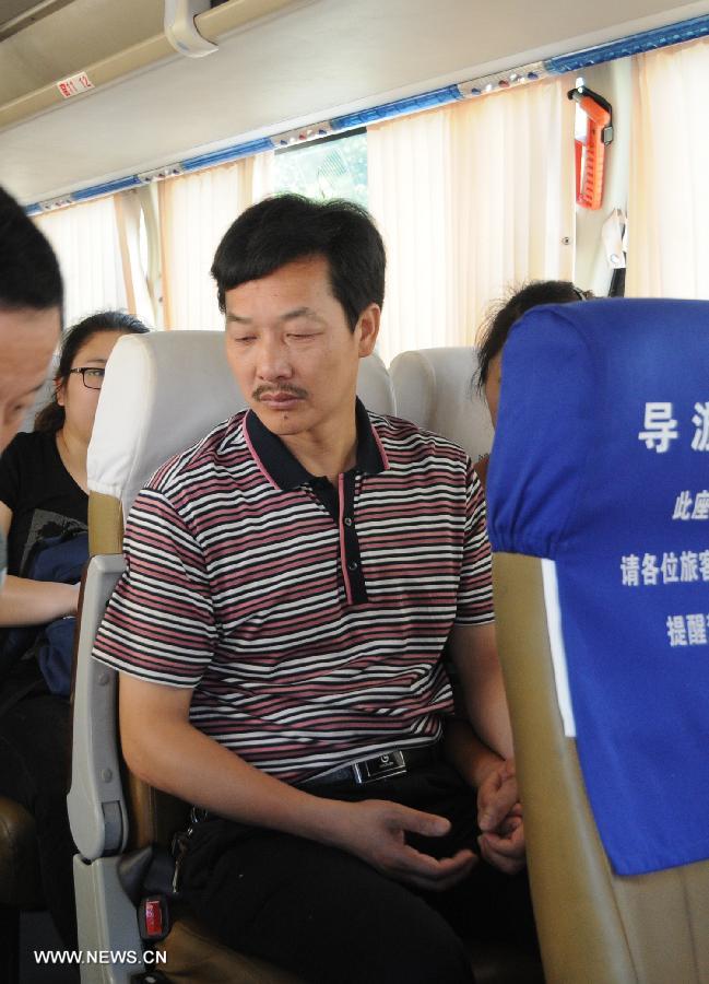 The relative of a victim in the Asiana Airlines' crash sits on the bus in Quzhou city, east China's Zhejiang Province, July 8, 2013. The victims' families of Asiana Airlines' crash prepared to fly to the U.S. to deal with the aftermath of the crash Monday morning. (Xinhua/Huang Shuifu)