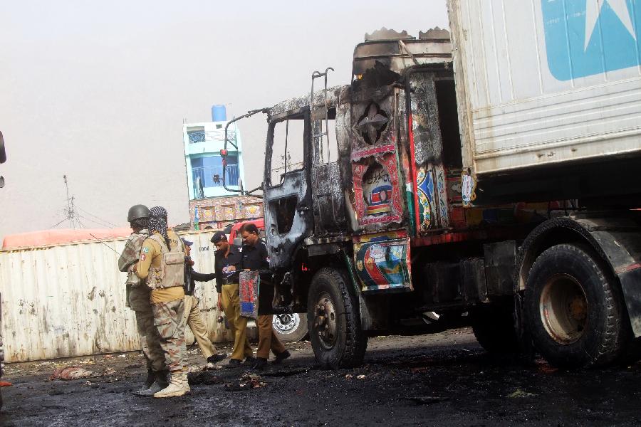 A burnt NATO supply truck is seen in southwest Pakistan's Quetta, on July 8, 2013. According to media reports, militants torched three NATO containers, with no casualties reported. (Xinhua/Mohammad)