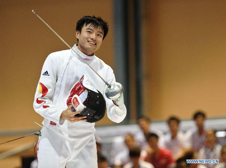 China's Dong Chao celebrates victory after the Men's Epee Individual Finals at the 27th Summer Universiade in Kazan, Russia, July 8, 2013. Dong claimed the title by defeating Kazakhstan's Ruslan Kurbanov with 15-10. (Xinhua/Jiang Kehong)