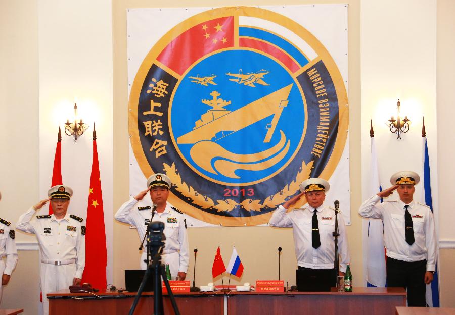 Naval officers from China and Russia salute at the opening of the joint naval drills in Vladivostok, Russia, July 8, 2013. China and Russia started on Monday the joint naval drills off the coast of Russia's Far East. (Xinhua/Zha Chunming) 