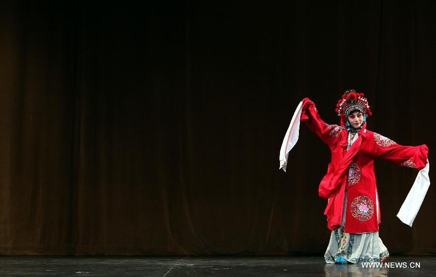 A Chinese artist performs Beijing Opera at the National Theater in Algiers, capital of Algeria, July 8, 2013. The performance was part of the celebrations to mark the 55th anniversary of the establishment of the diplomatic relations between China and Algeria. (Xinhua/Mohamed Kadri) 