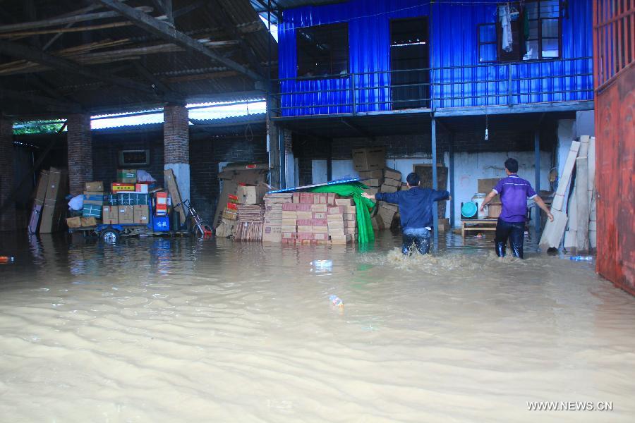 Photo taken on July 8, 2013 shows a flooded garage in Yingjiang County, southwest China's Yunnan Province. Rainstorm-triggered floods have affected about 4,882 people in the county, causing damages to local agriculture and houses. The rescue operation is under way. (Xinhua)