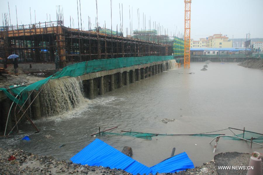 Photo taken on July 9, 2013 shows a flooded construction site in Yingjiang County, southwest China's Yunnan Province. Rainstorm-triggered floods have affected about 4,882 people in the county, causing damages to local agriculture and houses. The rescue operation is under way. (Xinhua)