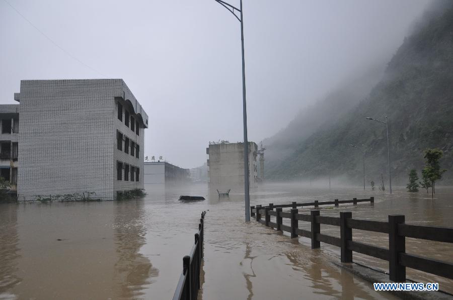Buildings are flooded in rainstorm-hit Beichuan Qiang Autonomous County, southwest China's Sichuan Province, July 9, 2013. Downpours have submerged the quake-razed old town ruins of Beichuan, which was hit by an 8.0-magnitude earthquake in May 2008. (Xinhua)