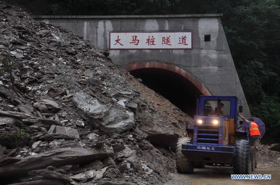 Rescuers open up landslide-blocked Damazhuang tunnel on 302 provincial road in Beichuan Qiang Autonomous County, southwest China's Sichuan Province, July 9, 2013. Downpours have submerged the quake-razed old town ruins of Beichuan, which was hit by an 8.0-magnitude earthquake in May 2008. (Xinhua)