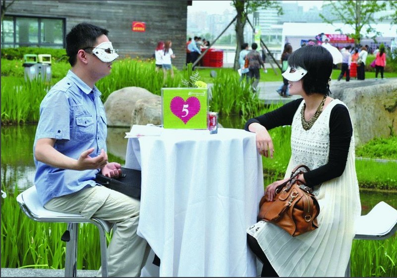 Two people chat during the blind date. Some pushy parents force their children to attend the face-to-face meetings. 