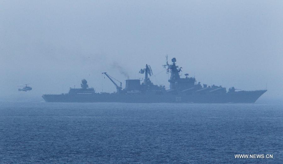 A Russian ship-borne helicopter is about to land on a vessel during the "Joint Sea-2013" drill at Peter the Great Bay in Russia, July 9, 2013. Chinese and Russian warships carried out a variety of exercises including joint air defense, maritime supply, joint escort and the rescue of hijacked vessels during the second day of "Joint Sea-2013" drill. (Xinhua/Zha Chunming)