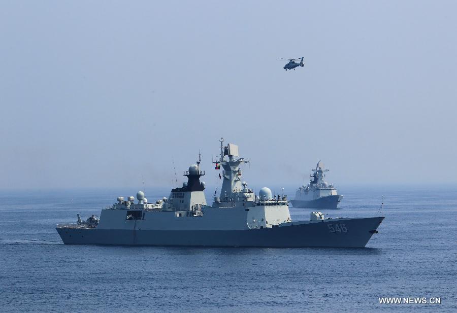 Chinese naval ships and a ship-borne helicopter attend the "Joint Sea-2013" drill at Peter the Great Bay in Russia, July 9, 2013. Chinese and Russian warships carried out a variety of exercises including joint air defense, maritime supply, joint escort and the rescue of hijacked vessels during the second day of "Joint Sea-2013" drill. (Xinhua/Zha Chunming)
