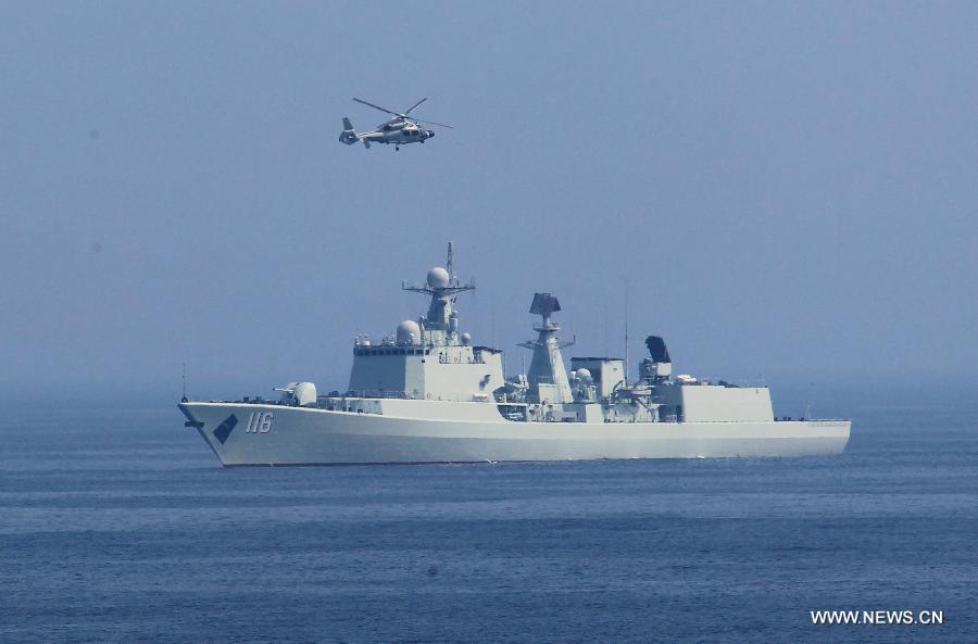 Chinese naval ships and a ship-borne helicopter attend the "Joint Sea-2013" drill at Peter the Great Bay in Russia, July 9, 2013. Chinese and Russian warships carried out a variety of exercises including joint air defense, maritime supply, joint escort and the rescue of hijacked vessels during the second day of "Joint Sea-2013" drill. (Xinhua/Zha Chunming)