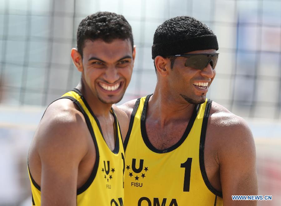 Al Belushi Hassan (R) and Al Subhi Faisal of Oman celebrate after winning men's beach volleyball match against China's Lin Minggui and Wang Dafa at the 27th Summer Universiade in Kazan, Russia, July 9, 2013. Al Belushi Hassan and Al Subhi Faisal won 2-0. (Xinhua/Meng Yongmin)