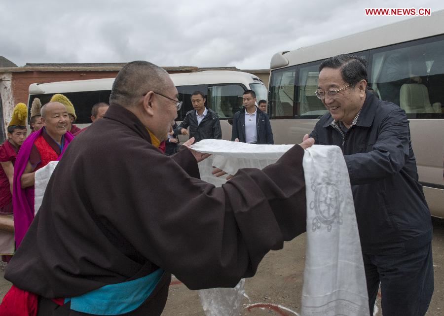 Yu Zhengsheng (1st R), a member of the Standing Committee of the Political Bureau of the Communist Party of China (CPC) Central Committee and chairman of the National Committee of the Chinese People's Political Consultative Conference, visits religious figures at the Labrang Monastery in Gannan Tibetan Autonomous Prefecture, northwest China's Gansu Province, July 8, 2013. Yu made an inspection tour in Gannan recently. (Xinhua/Li Xueren)