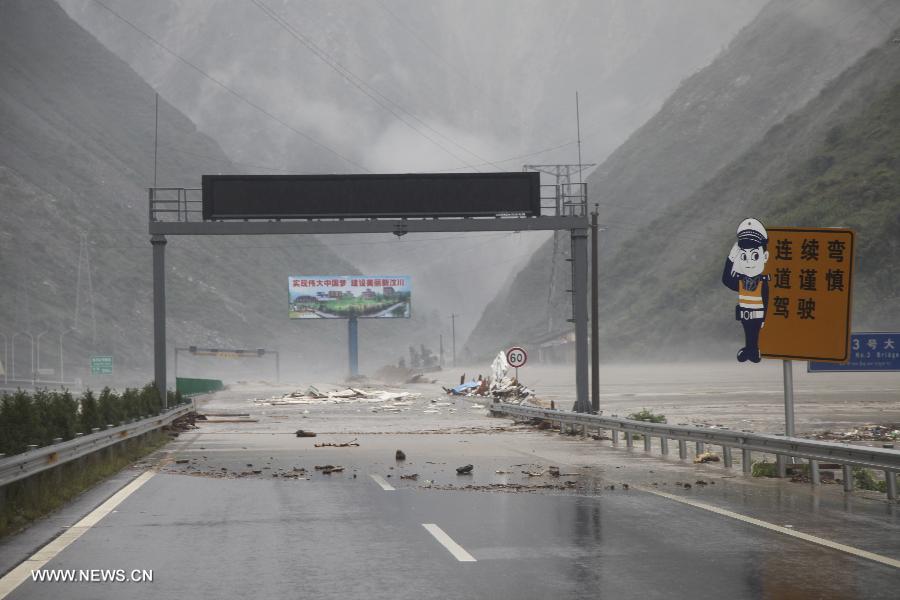 A bridge is flooded at Caopo Township in Wenchuan County, southwest China's Sichuan Province, July 10, 2013. Rainstorms battered the county in these two days. (Xinhua/Lu Guotong)
