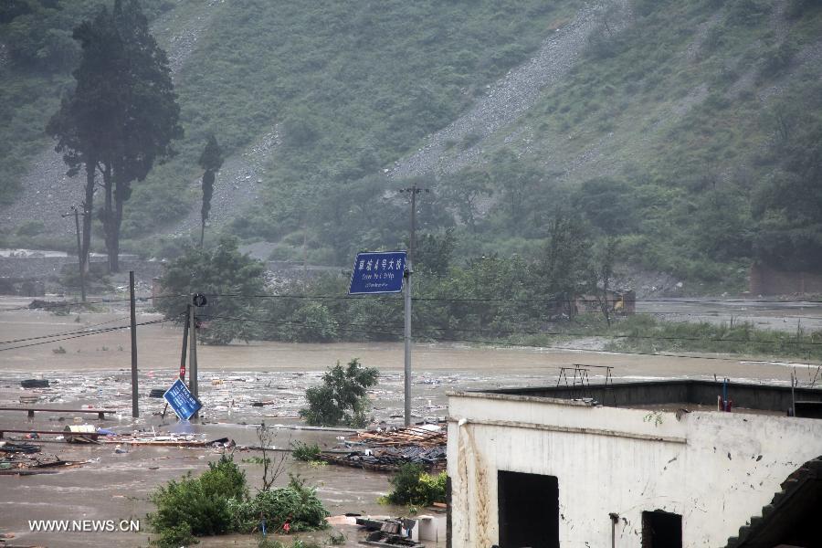 Caopo No. 4 Bridge on State Highway 213 is flooded in Caopo Township of Wenchuan County, southwest China's Sichuan Province, July 10, 2013. Rainstorms battered the county in these two days. (Xinhua/Lu Guotong)