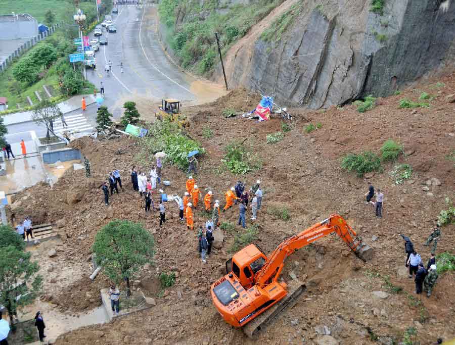 Rescuers work at the mudflow site in Pingwu County of Mianyang City, southwest China's Sichuan Province, July 10, 2013. A section of the Jiuzhaigou ring highway was hit by a mudflow in Pingwu on Wednesday noon. No casualties have been reported yet. Rescue work is under way. (Xinhua/Hu Yu)
