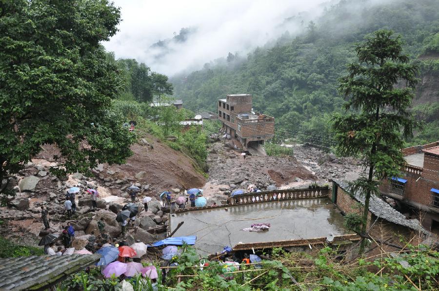 Photo taken on July 10 shows the flood-hit Huiwang Village of Suijiang County, southwest China's Yunnan Province. Rain-triggered mountain torrents and landslides hit five townships of the county in these two days, leaving four people dead. (Xinhua/Tan Pingcai) 