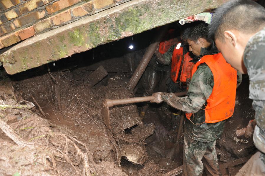 Rescuers search for the trapped villagers at flood-hit Huiwang Village of Suijiang County, southwest China's Yunnan Province, July 10, 2013. Rain-triggered mountain torrents and landslides hit five townships of the county in these two days, leaving four people dead. (Xinhua/Tan Pingcai) 