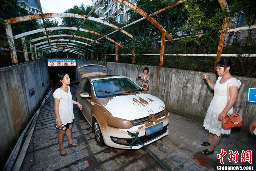 It has been four days since the torrential rains pounded the city, but car owners’ efforts to save their flooded cars in underground garages were not still underway. (Photo/CNS)