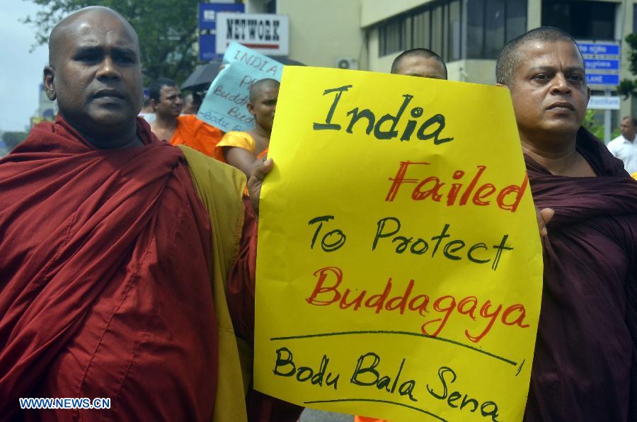 Two Sri Lankan Buddhist monks participate in a protest march near the Indian High Commission of Colombo, capital of Sri Lanka, July 10, 2013. The protest aims to urge the Indian authorities to protect Buddhism, Buddhists and Buddhist cultural heritage sites in India following a bomb attack on an Indian Buddhist temple on July 7. (Xinhua/Sameera)