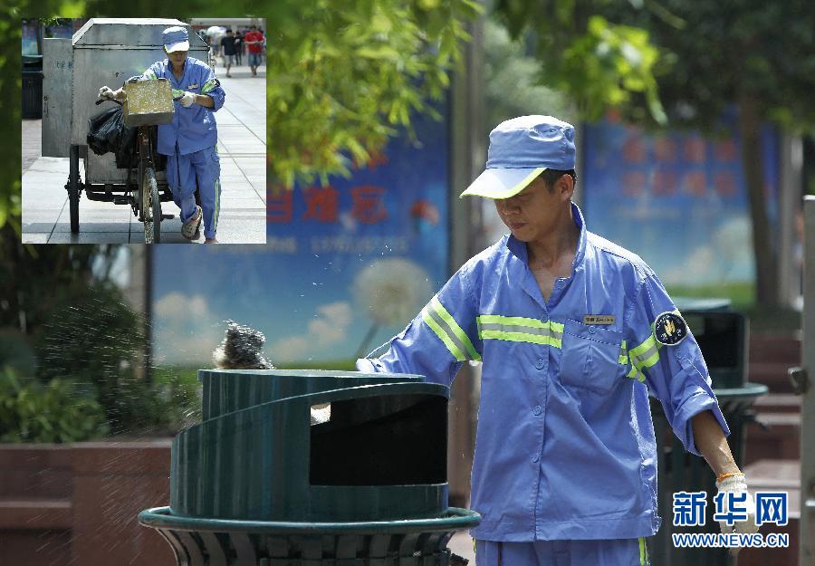 Su, a cleanser, washes the garbage can on Nanjing Road in Shanghai, July 3, 2013, Su, 37, from Anhui province, works eight hours a day. Shanghai issued yellow warning of high temperature on July 3, 2013. The maximum temperature exceeded 35 degrees Celsius. (Xinhua/Ding Ding) 